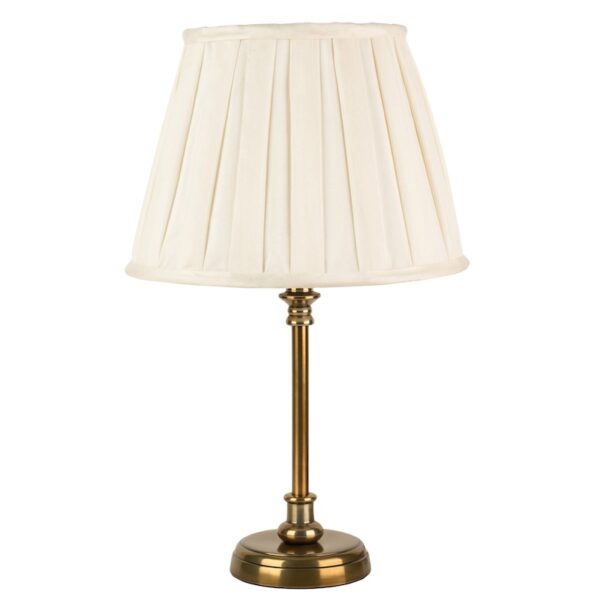 a small antique brass stick base with a an ivory box pleated shade.